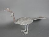 l'image d'un oiseau en métal aux longues pattes et au long bec
