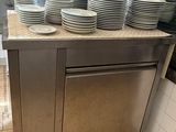 many plates stacked on top of a counter in a kitchen