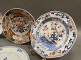several plates with different designs are sitting on a table