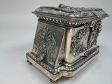 a silver box sitting on top of a white table