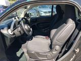 the interior of a car with the door open showing the driver ' s seat and steering wheel