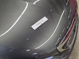 a sticker on the hood of a car that is parked