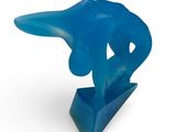 blue sculpture of a hand holding a blue object on a white surface
