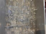 a box full of empty wine glasses sitting on the floor