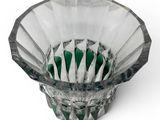 a glass bowl with toothbrushes in it on a white surface