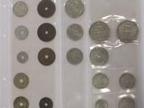 several different types of coins are in a clear plastic case