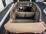 a car that is sitting in the street with a cloth on the seat
