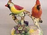 two birds that are sitting on a tree branch
