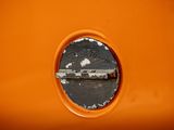 a small hole in the side of an orange wall