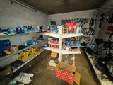 a room with a lot of items on the shelves