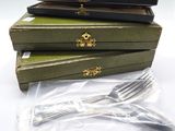a stack of three wooden boxes with silverware in them