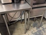 a small table with a microwave and a toaster on it