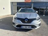 the front of a silver car parked in front of a building