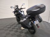 a motorcycle that is parked in a room with a checkered floor