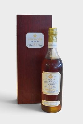 a bottle of whisky sitting next to a wooden box