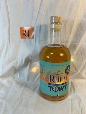 a bottle of rum that is sitting on a white sheet