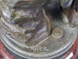 a close up of a statue of a person with a glove on