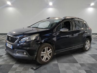 the black car is parked on a checkered floor in the garage