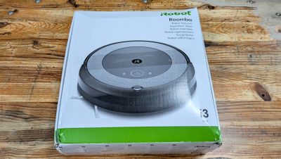 packaging for a robot vacuum cleaner on a wooden table