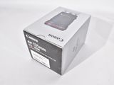 the box is open on a white table with a camera in it