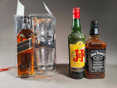 bottles of alcohol and glasses are lined up on a table