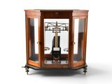 a clock that is sitting inside of a glass case