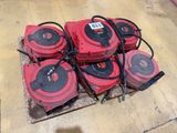 a pile of red and black vacuums on a pallet