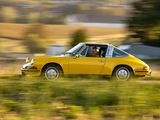 a yellow car that is driving down the road