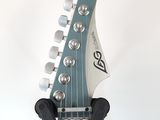 a close up of an electric guitar with a headstock