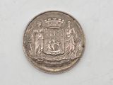 an old silver coin with a coat of arms on it