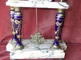 a purple and gold vase with a clock on it