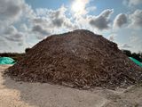 a large pile of wood chips on the ground
