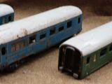 four toy trains sitting on a table next to each other