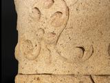a close up of a stone vase with a design on it