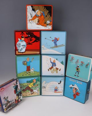 many different tin lunch boxes stacked on top of each other