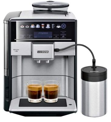 a close up of a coffee machine with two cups of coffee