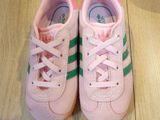 pair of pink and green sneakers on a wooden floor