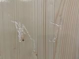 a close up of a wood panel with some paint on it