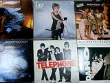 a lot of different album covers on a table