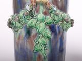 a blue vase with a bird on top of it