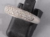 a close up of a diamond ring on a black glove