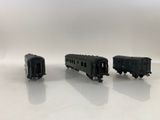 three toy trains on a white surface with a white background