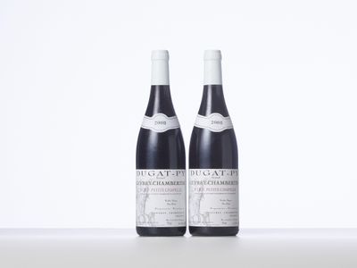 two bottles of wine sitting on top of a white table