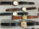 several different types of watches are lined up on a table