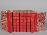 six red books stacked on top of each other in a row