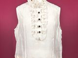a white top with ruffles and buttons on a mannequin mannequin