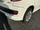a small white car parked in a parking lot