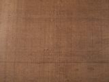 a close up of a piece of wood with a brown background