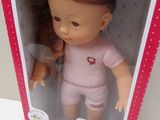 packaging of a doll in a box with a doll inside of it