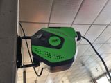 a green and black machine that is on the ceiling